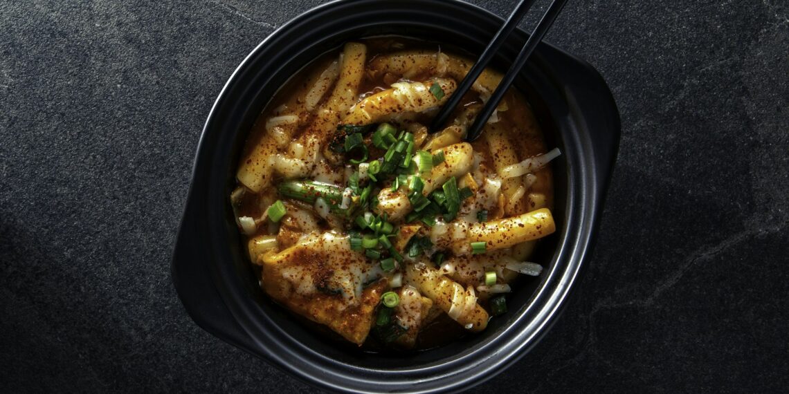 Bowl of spicy tteokbokki, a popular Korean street food you can find in Dubai