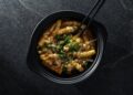 Bowl of spicy tteokbokki, a popular Korean street food you can find in Dubai