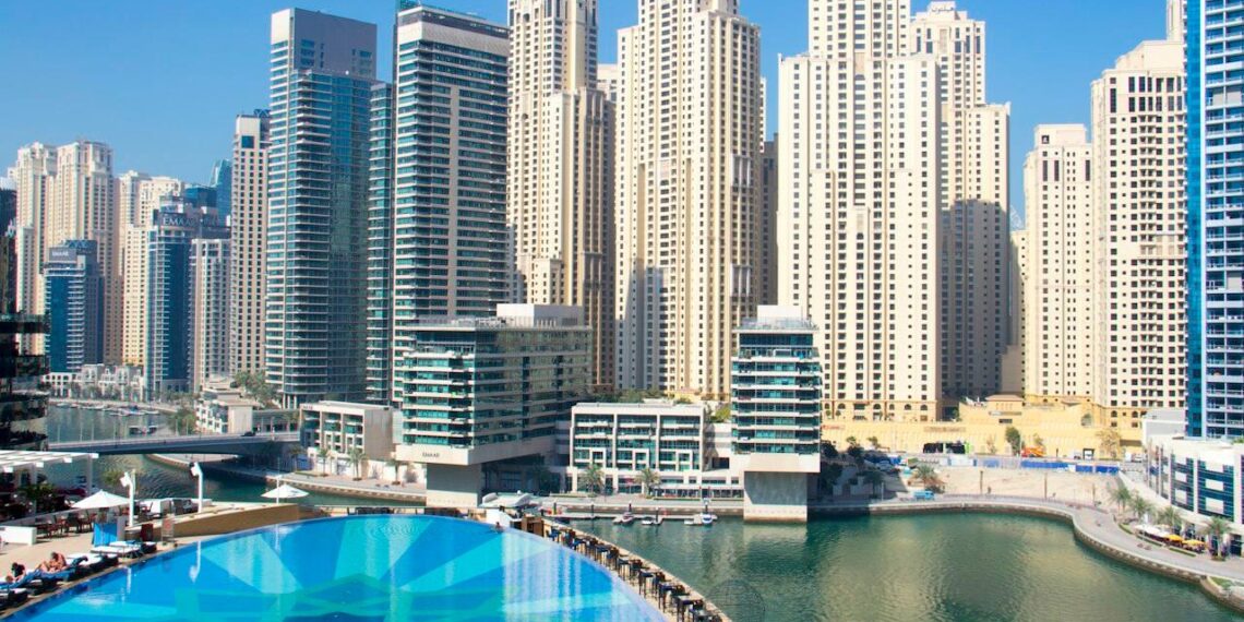 Residential apartment towers and a pool in Dubai Marina, a popular area for renting an apartment in Dubai