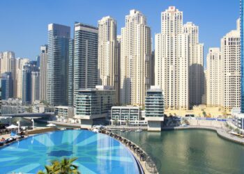 Residential apartment towers and a pool in Dubai Marina, a popular area for renting an apartment in Dubai